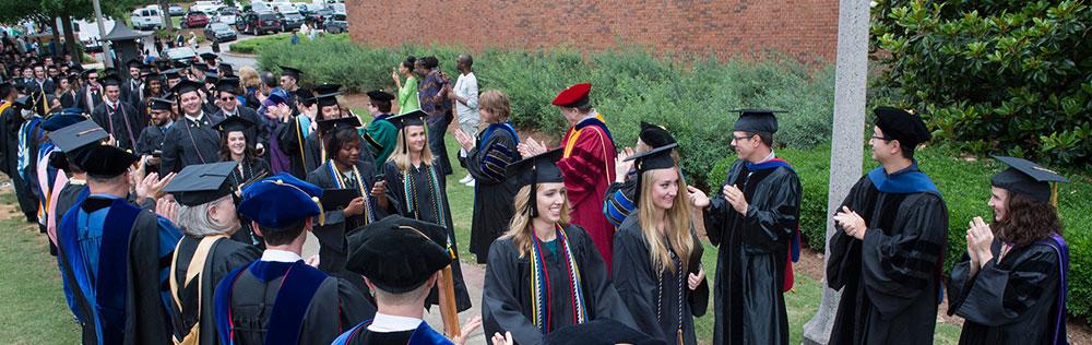 Graduates "walking through" faculty lineup